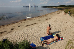 bathers-enjoy-the-beach-at-baerwalder-see-lake-as-exhaust-rises-from-picture-id103338199.jpg